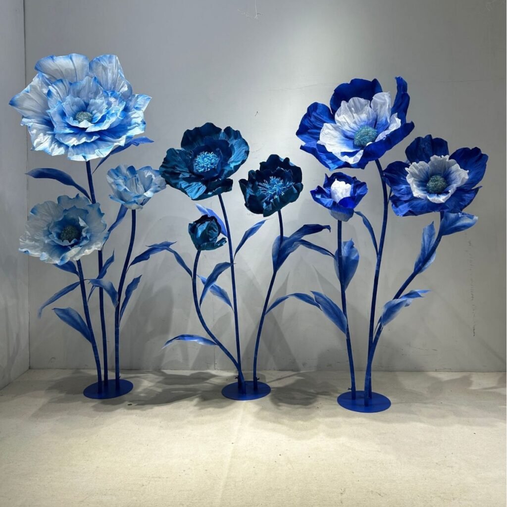 Large blue artificial flowers, suitable for wedding venue decorations and shop window displays.